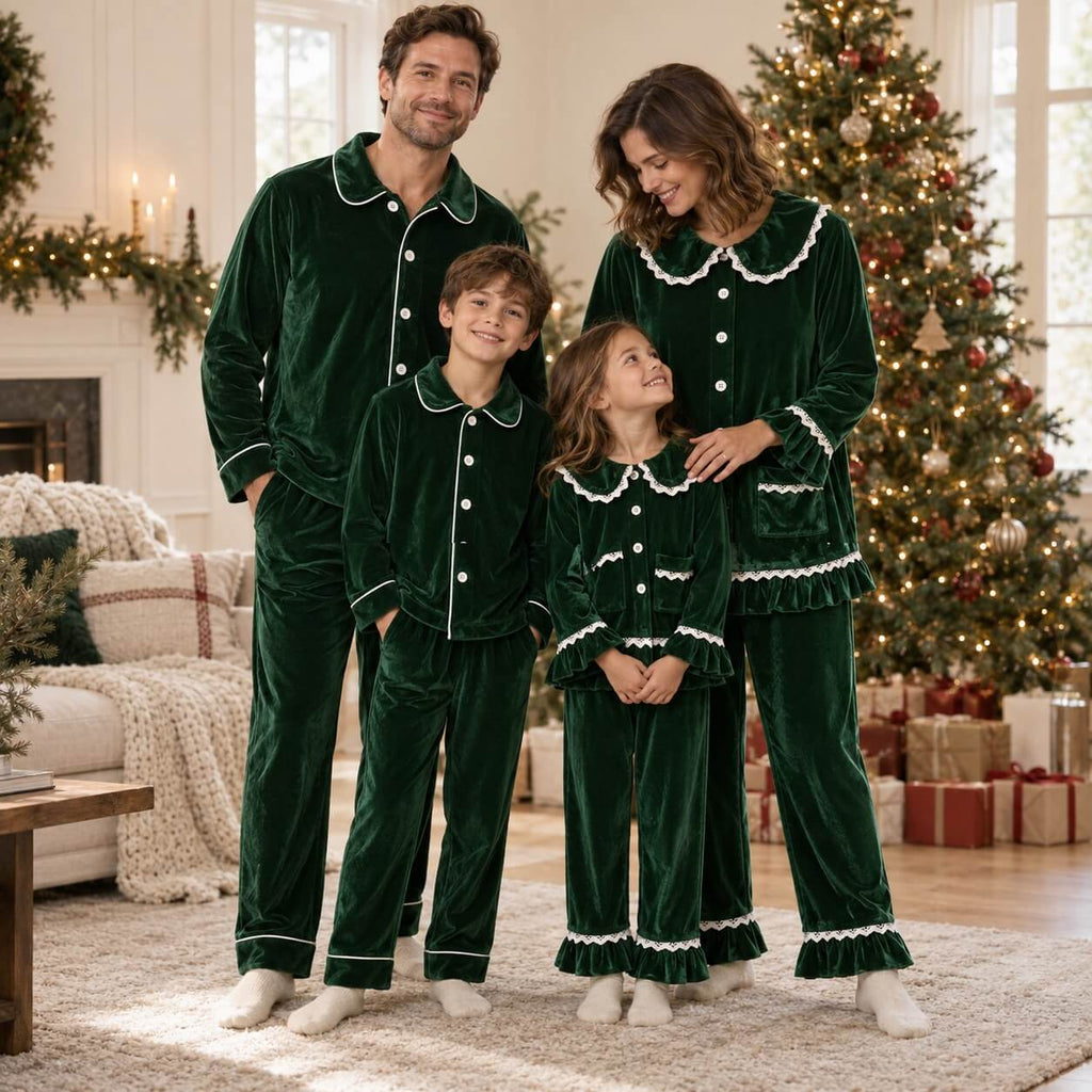 Family wearing matching green velvet Christmas pyjamas with white piping and lace ruffle trim