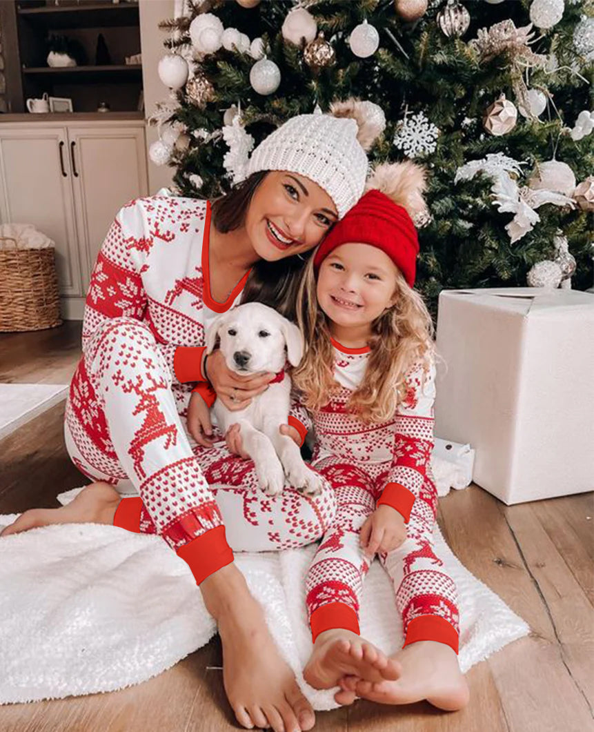 Family matching Christmas pyjamas in red and white reindeer and snowflake print