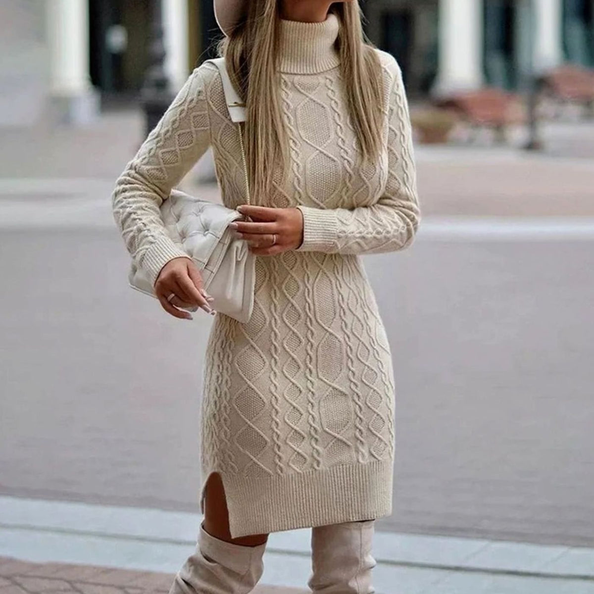 Woman wearing a fitted cable knit turtleneck sweater dress with side slit and knee-high boots - view 3