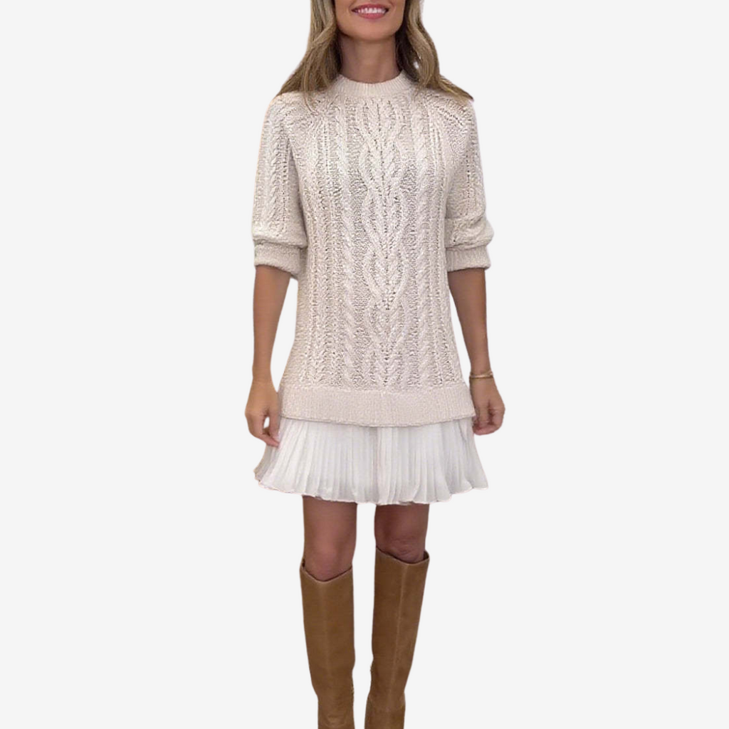 Woman wearing a cable knit jumper dress with ribbed crew neck and pleated mini hem - view 3