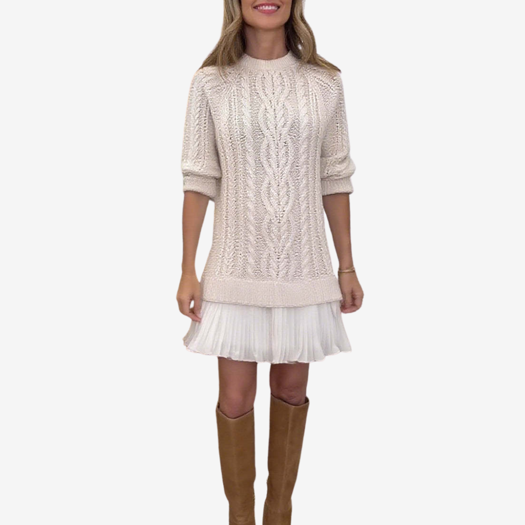 Woman wearing a cable knit jumper dress with ribbed crew neck and pleated mini hem - view 3