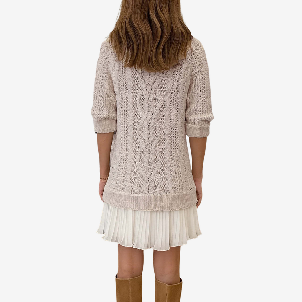 Woman wearing a cable knit jumper dress with ribbed crew neck and pleated mini hem - view 4