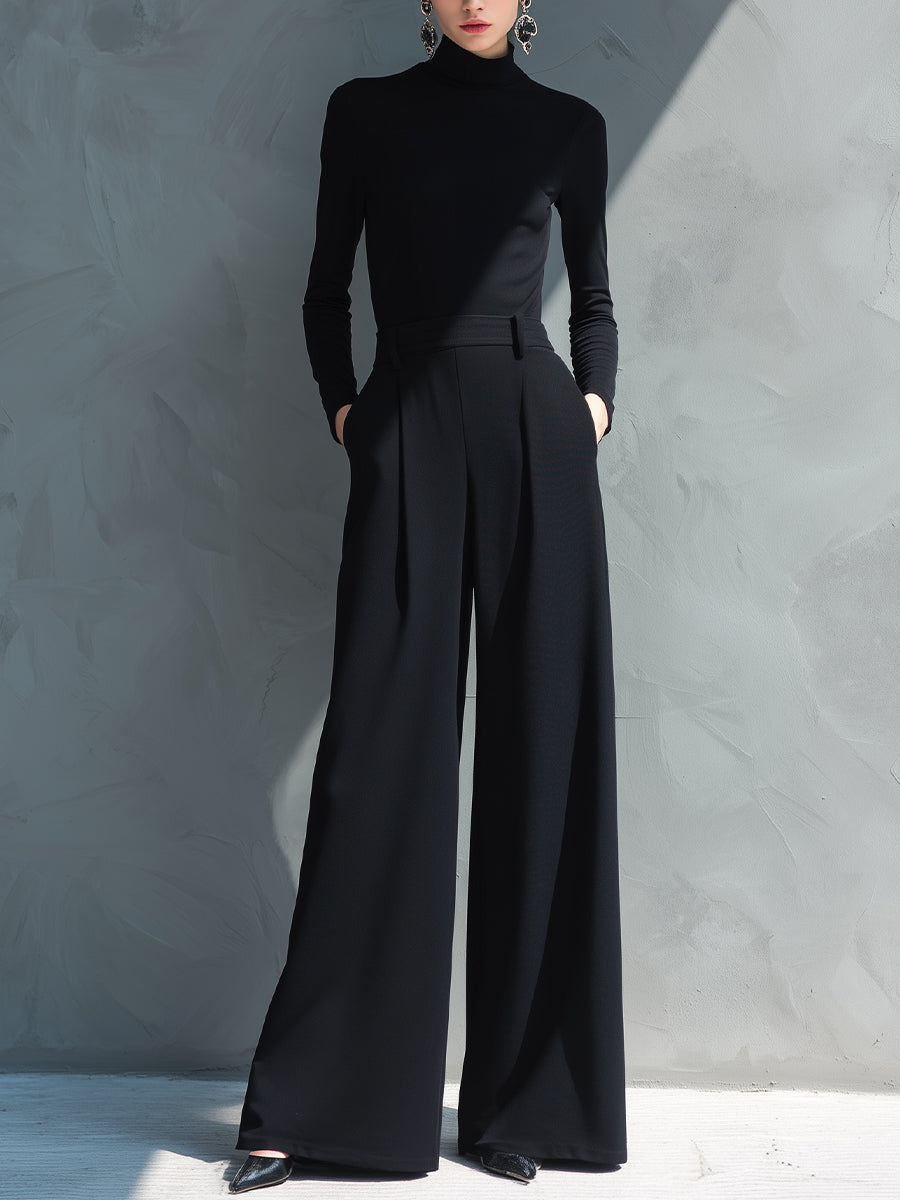 Black wide leg jumpsuit with turtleneck, defined waistband and floor-length hem