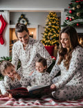 Matching family Christmas pyjamas with green watercolour pine tree print on white