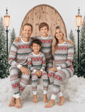 Family wearing matching Fair Isle Christmas pyjamas with reindeer and snowflake print