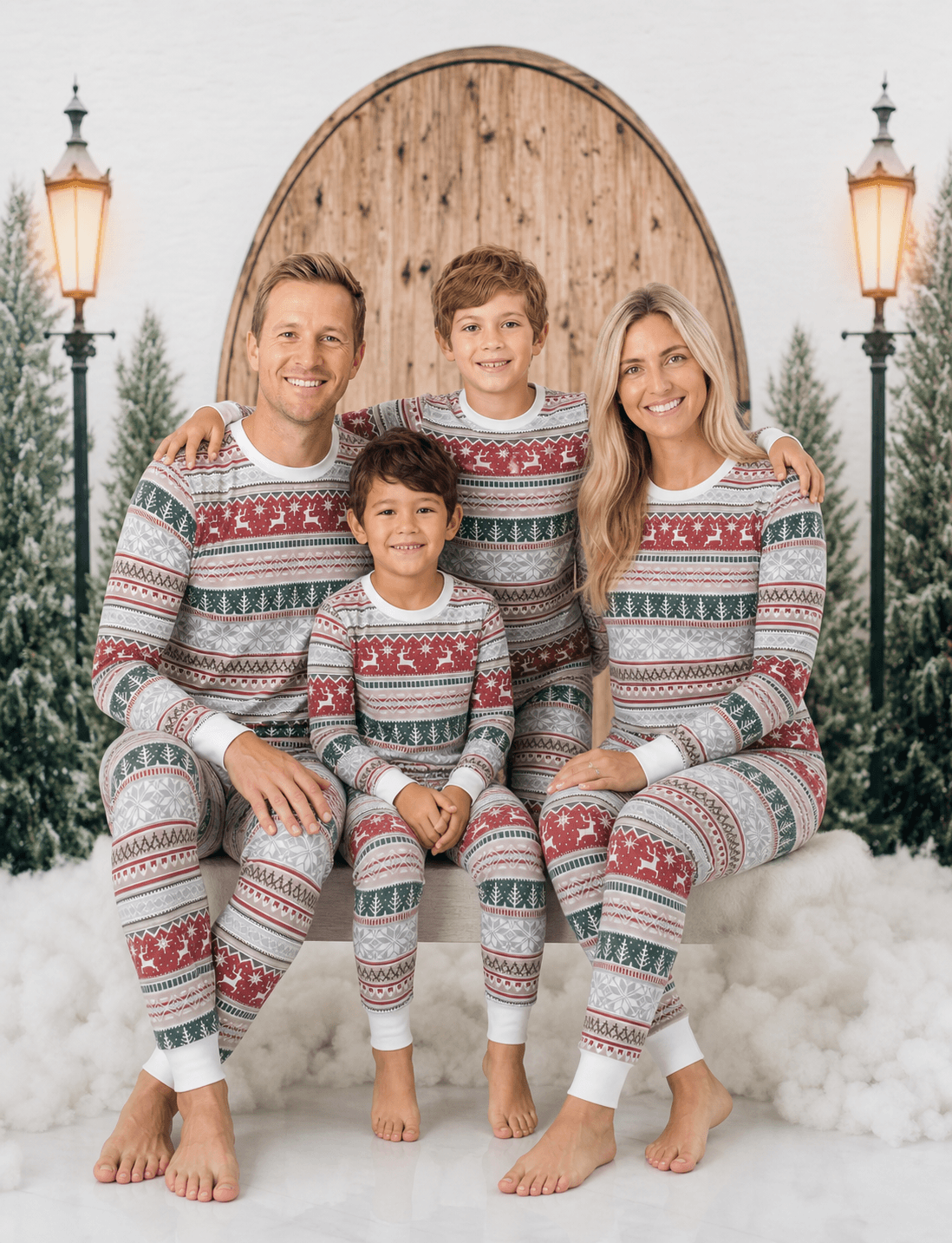 Family wearing matching Fair Isle Christmas pyjamas with reindeer and snowflake print