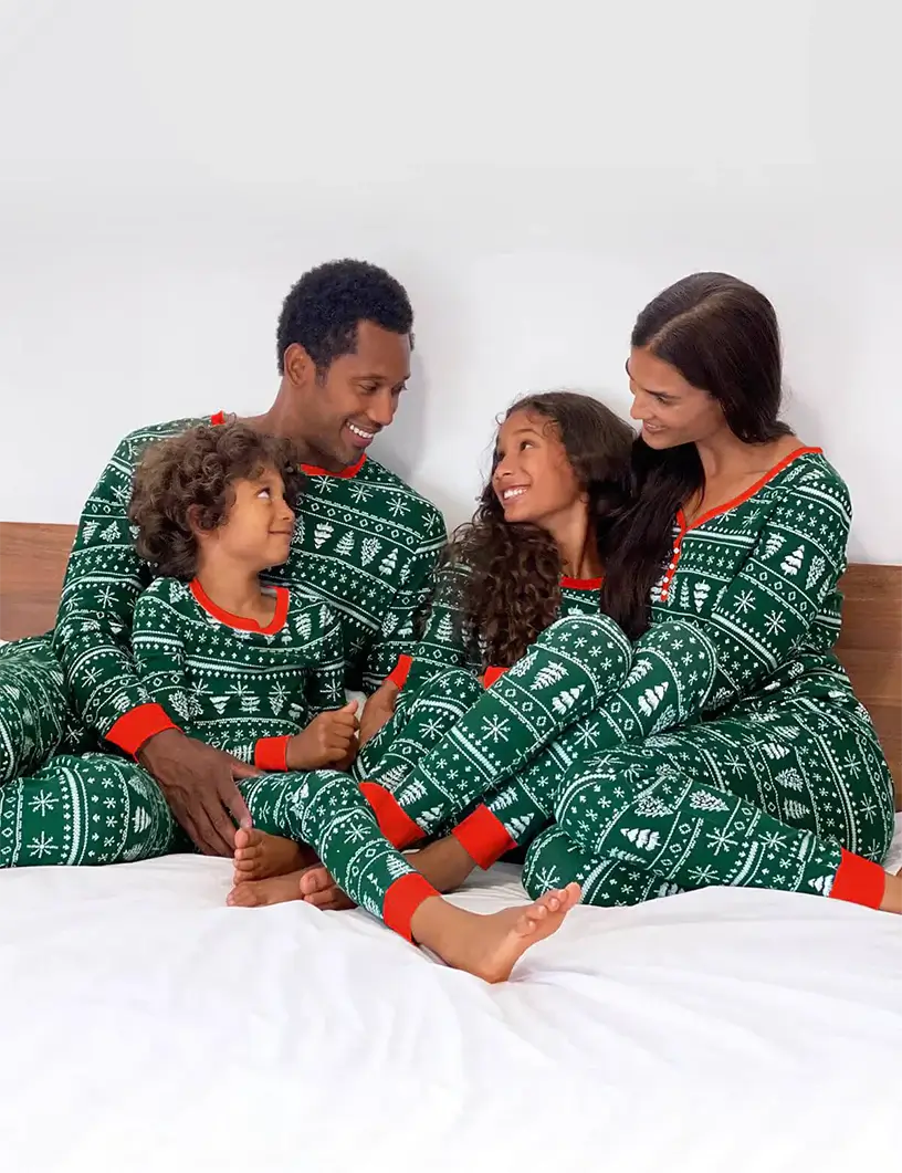 Family wearing matching green Fair Isle print Christmas pyjamas with red ribbed cuffs - view 8