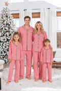 Red and white candy stripe matching family Christmas pyjamas with green piping