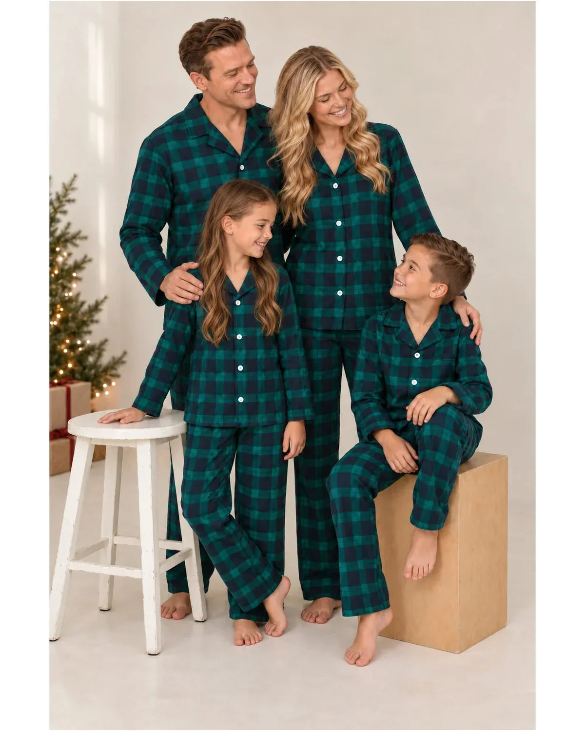 Family wearing matching green and navy tartan flannel Christmas pyjamas - view 3