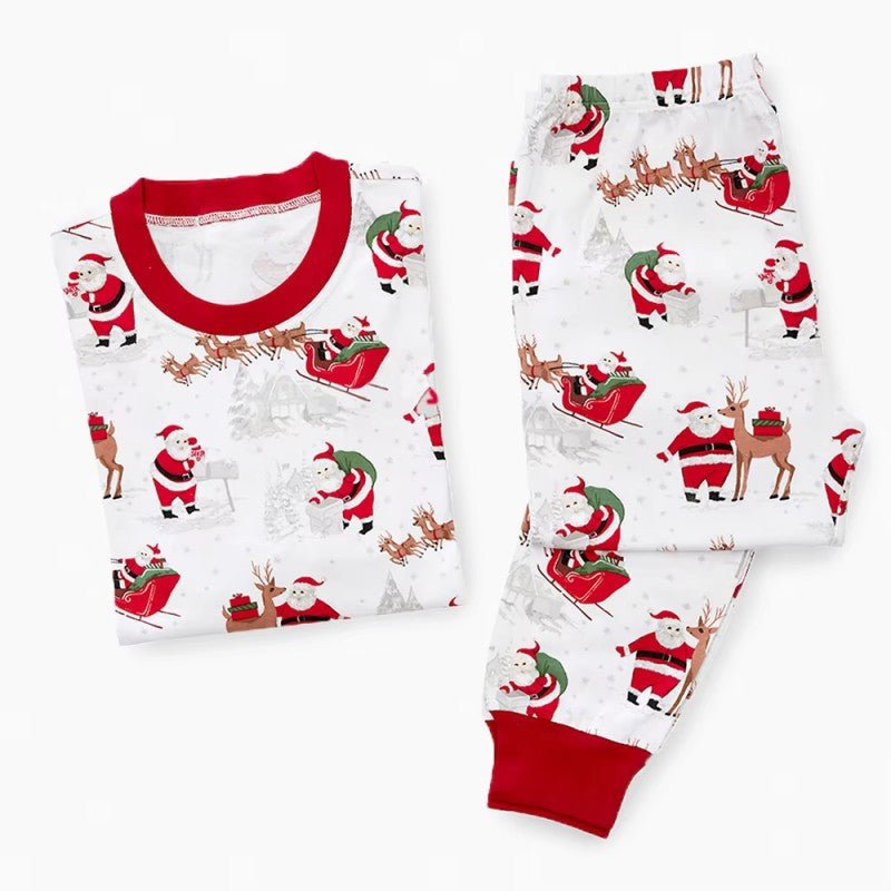 Matching family Christmas pyjamas with reindeer and Santa sleigh print and red ribbed trims - view 10