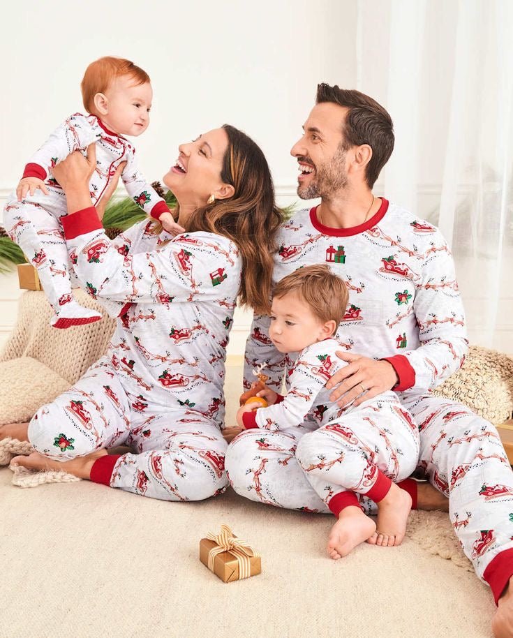 Matching family Christmas pyjamas with reindeer and Santa sleigh print and red ribbed trims - view 2