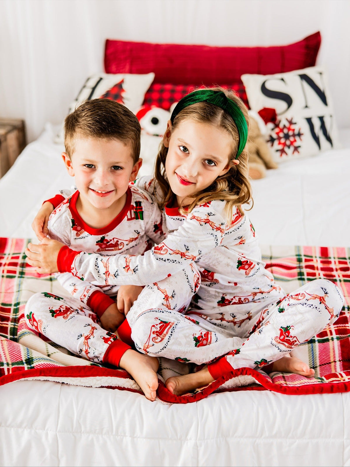 Matching family Christmas pyjamas with reindeer and Santa sleigh print and red ribbed trims - view 4
