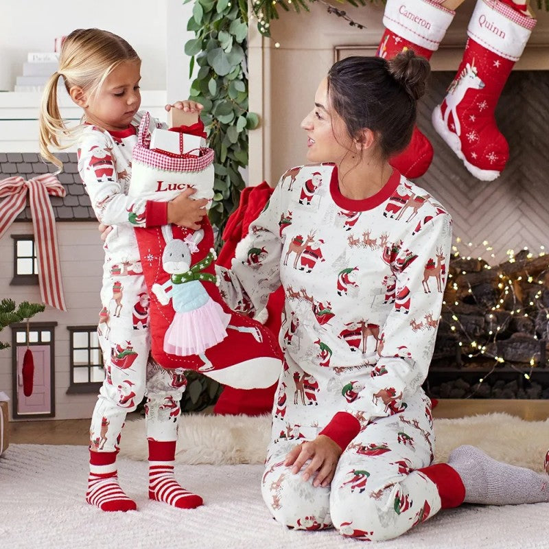 Matching family Christmas pyjamas with reindeer and Santa sleigh print and red ribbed trims - view 6
