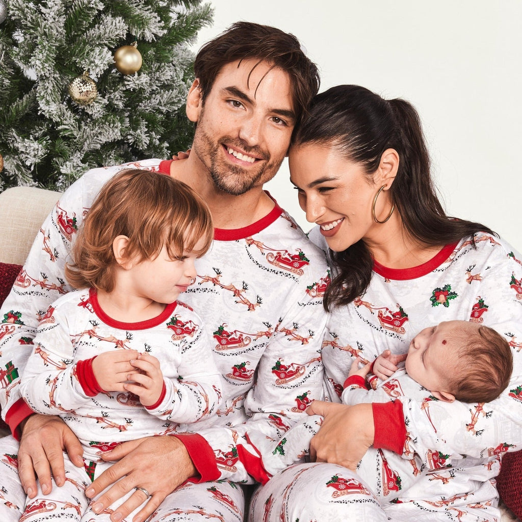 Matching family Christmas pyjamas with reindeer and Santa sleigh print and red ribbed trims - view 7