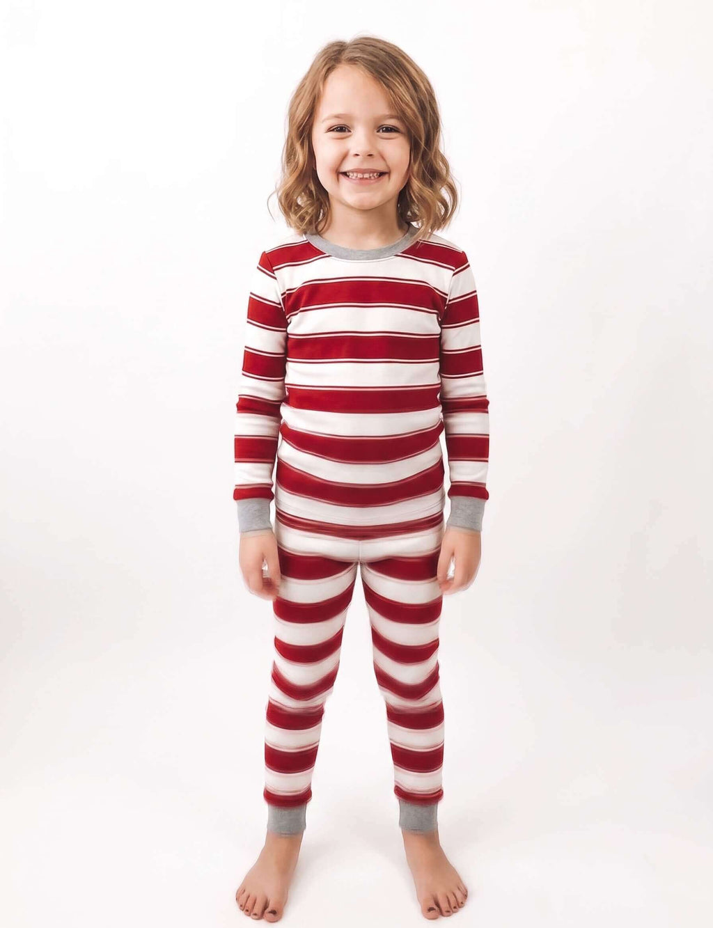 Family wearing matching red and white striped Christmas pyjamas with grey ribbed cuffs and a grey henley top - view 10