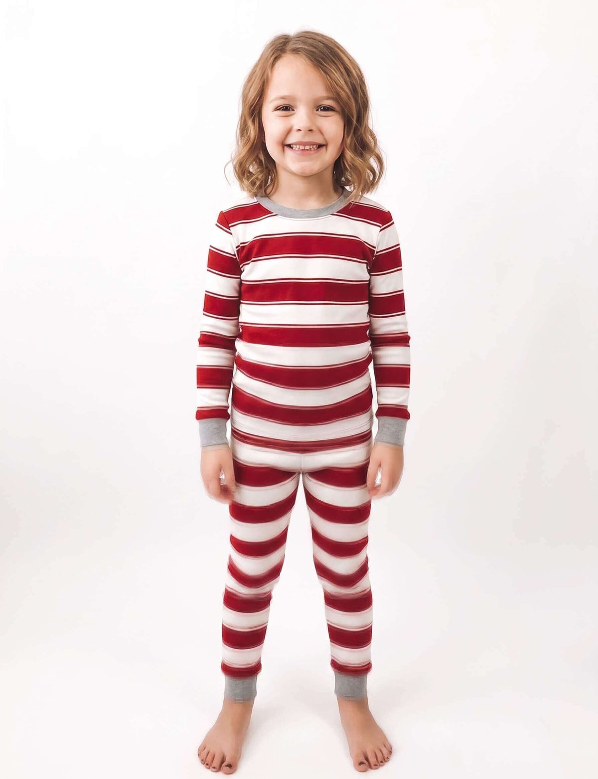 Family wearing matching red and white striped Christmas pyjamas with grey ribbed cuffs and a grey henley top - view 10