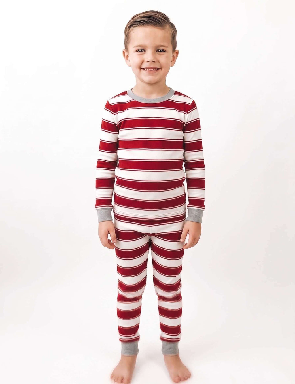 Family wearing matching red and white striped Christmas pyjamas with grey ribbed cuffs and a grey henley top - view 11