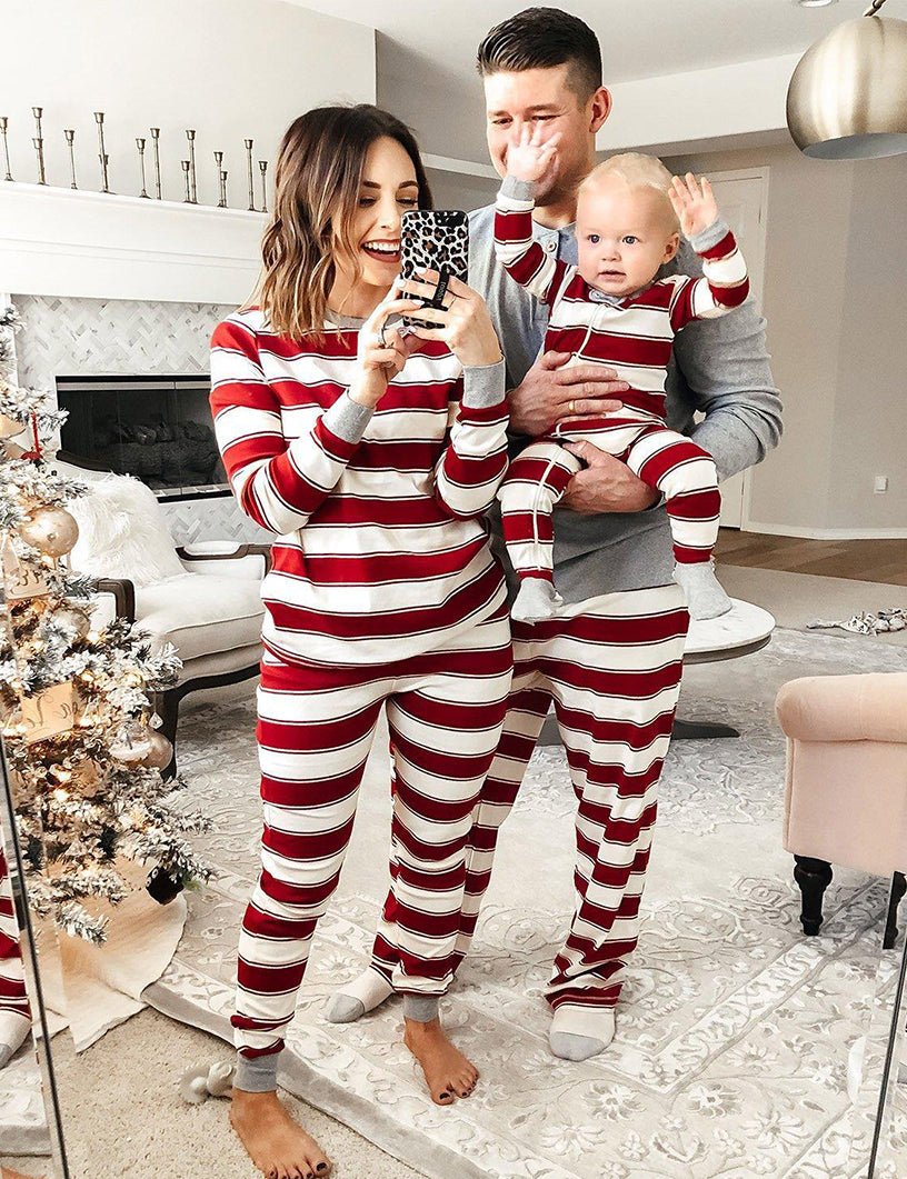 Family wearing matching red and white striped Christmas pyjamas with grey ribbed cuffs and a grey henley top - view 12