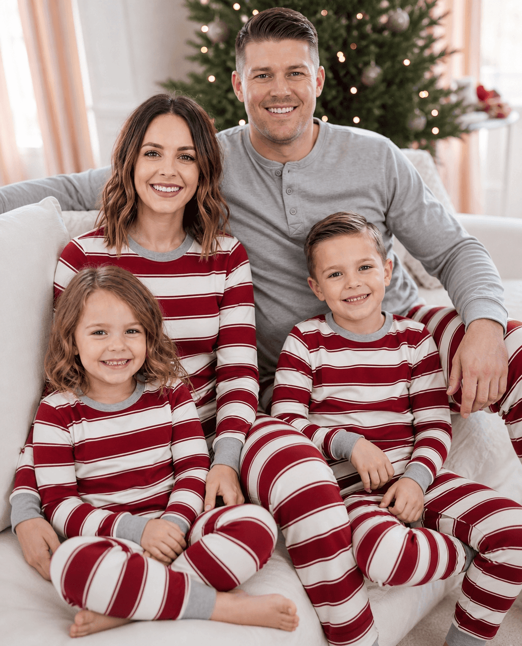 Family wearing matching red and white striped Christmas pyjamas with grey ribbed cuffs and a grey henley top - view 4