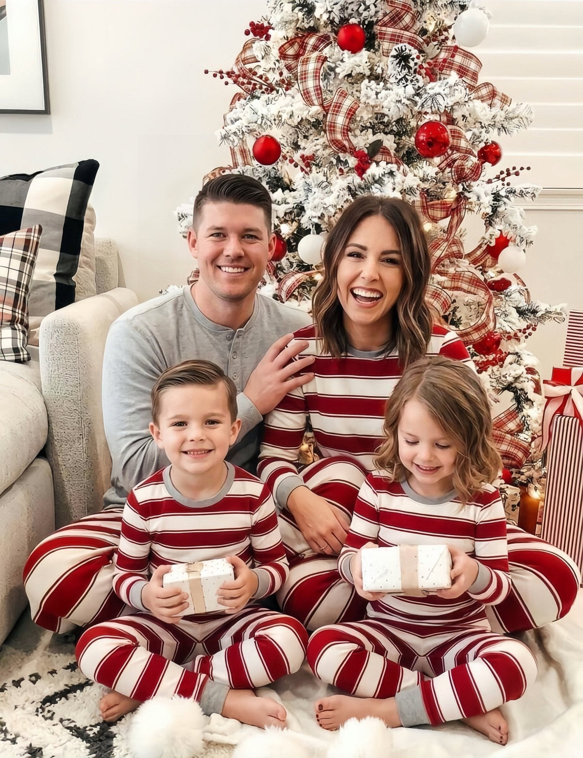 Family wearing matching red and white striped Christmas pyjamas with grey ribbed cuffs and a grey henley top - view 5