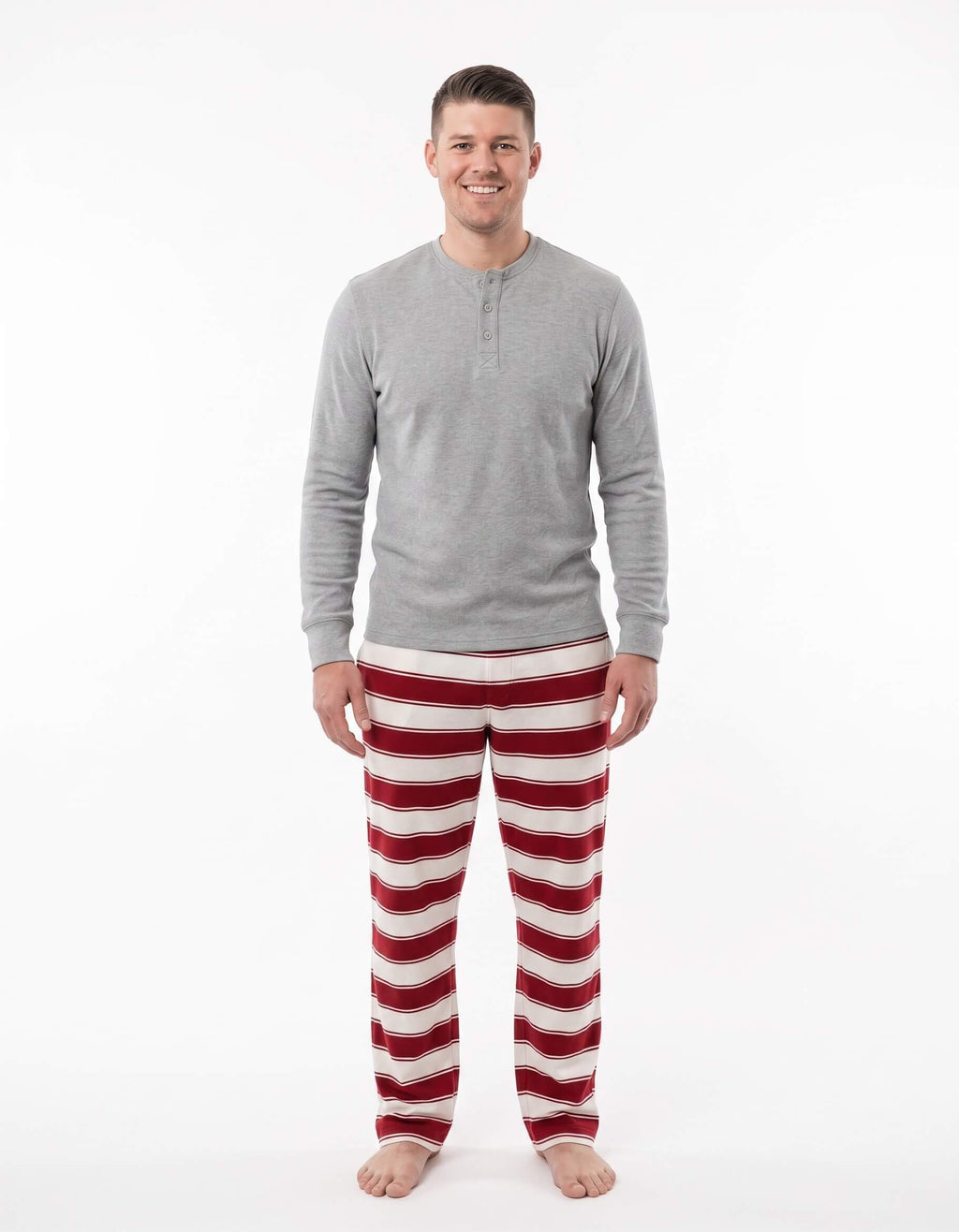 Family wearing matching red and white striped Christmas pyjamas with grey ribbed cuffs and a grey henley top - view 8