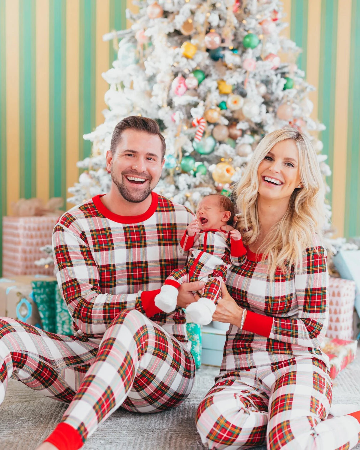 Family wearing matching cream and red tartan Christmas pyjamas with red ribbed cuffs - view 15