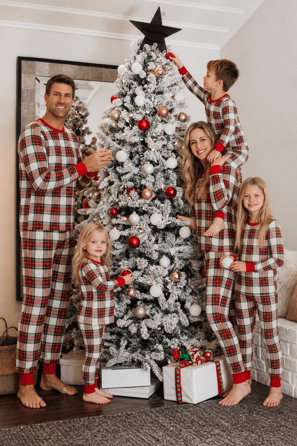 Family wearing matching cream and red tartan Christmas pyjamas with red ribbed cuffs - view 3