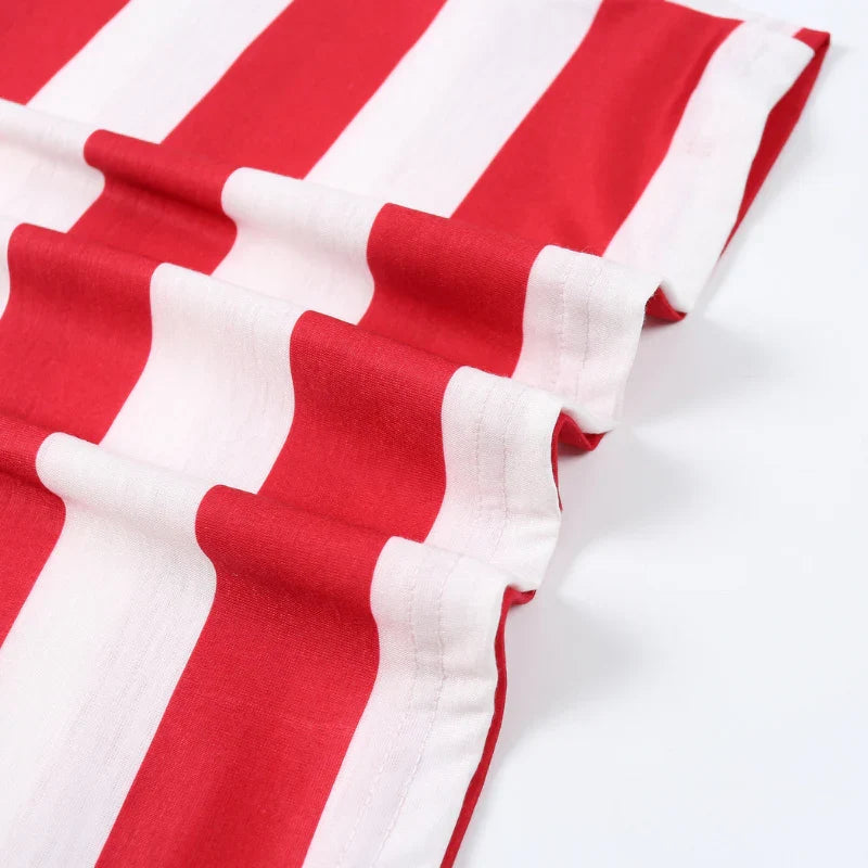 Family wearing matching red and white candy cane stripe Christmas pyjamas with grey ribbed trims - view 13