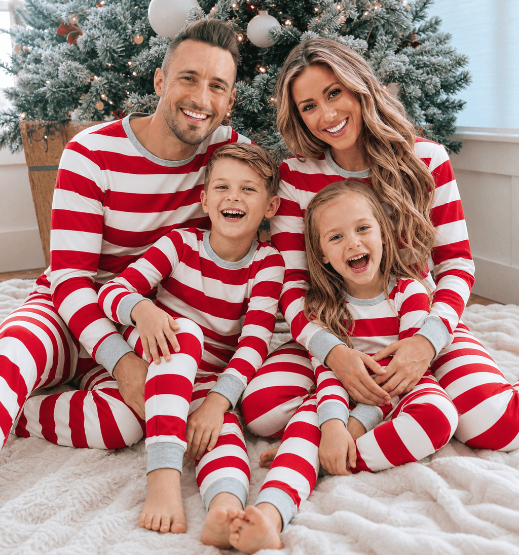 Family wearing matching red and white candy cane stripe Christmas pyjamas with grey ribbed trims - view 5