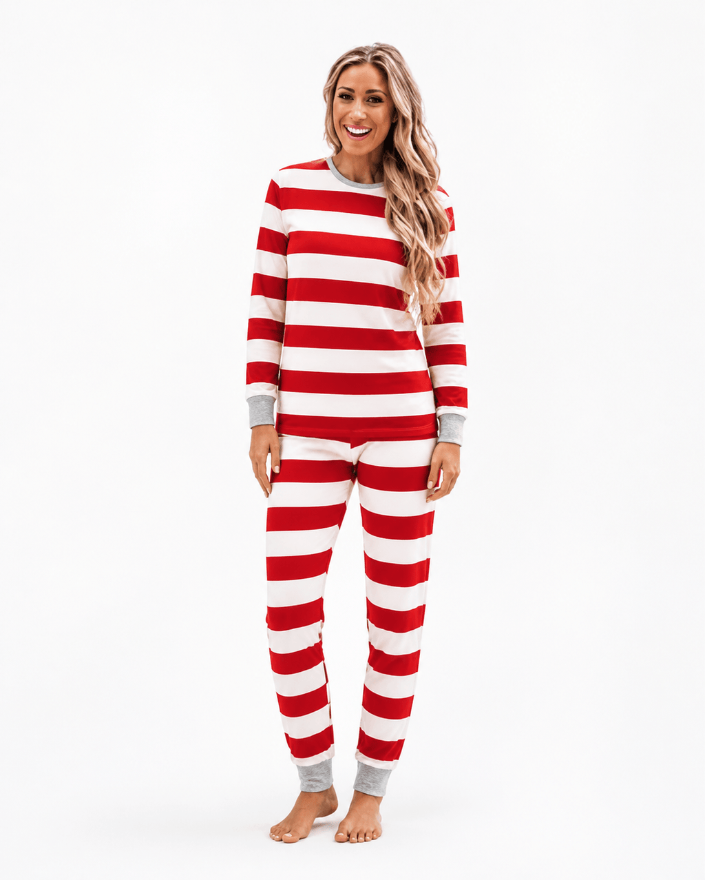 Family wearing matching red and white candy cane stripe Christmas pyjamas with grey ribbed trims - view 8
