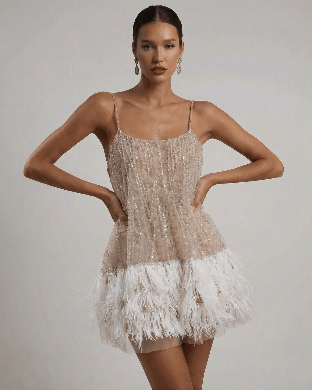 Nude sequin mini dress with white feather hem and open back