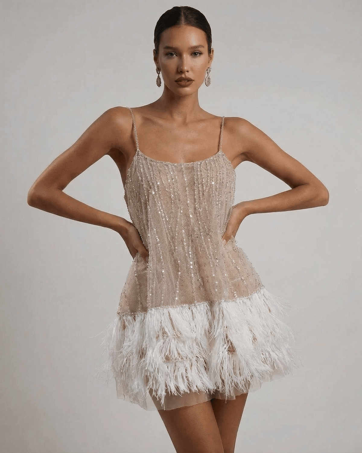 Nude sequin mini dress with white feather hem and open back