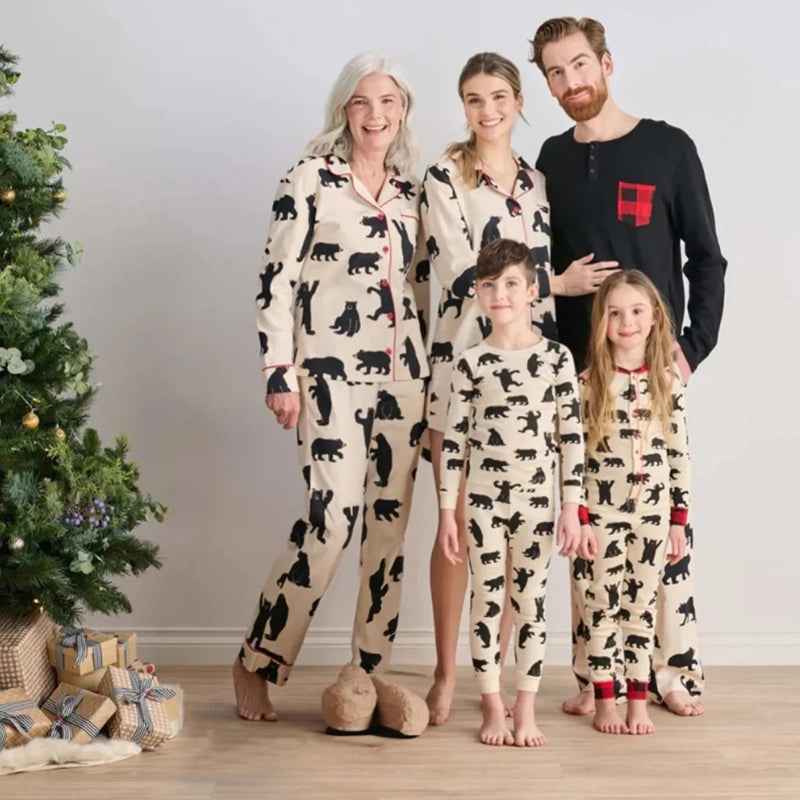 Men's bear print Christmas pajamas with black long-sleeve top by a fireplace - view 2