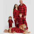 Matching family Christmas pyjamas in red tartan plaid for adults, kids, baby and dog