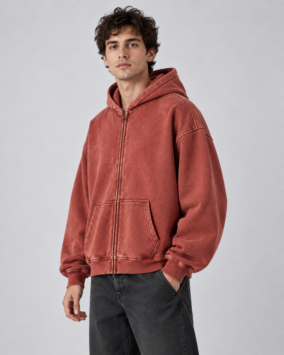 Man wearing an oversized washed zip up hoodie with kangaroo pocket and ribbed cuffs