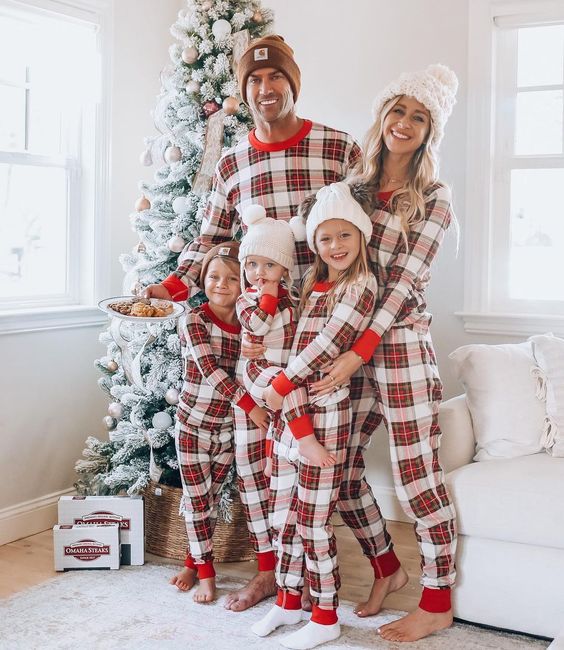 Family wearing matching red and white tartan Christmas pyjamas with red ribbed cuffs - view 2